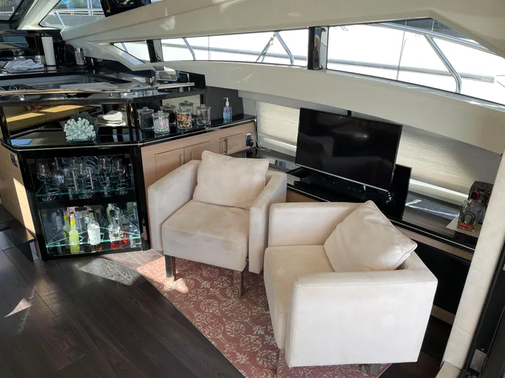 Why Knot Yacht Photos Pics Luxurious interior of 2011 Marquis Sport Coupe yacht with plush seating and modern amenities.