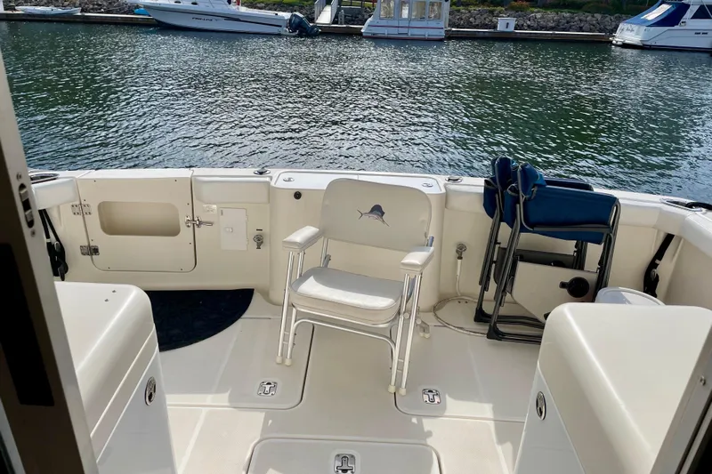  Yacht Photos Pics 2003 Silverton 38 Convertible boat deck with seating, docked by the water.