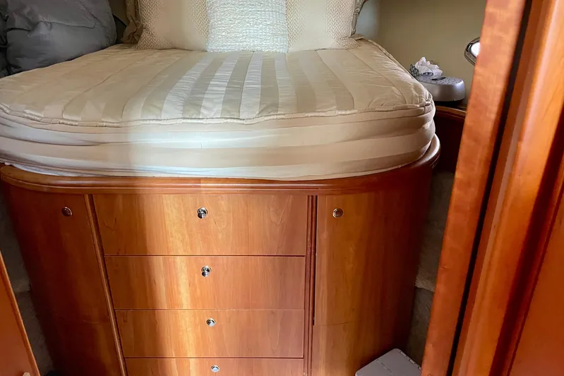  Yacht Photos Pics 2003 Silverton 38 Convertible cabin with wooden drawers and a neatly made bed.