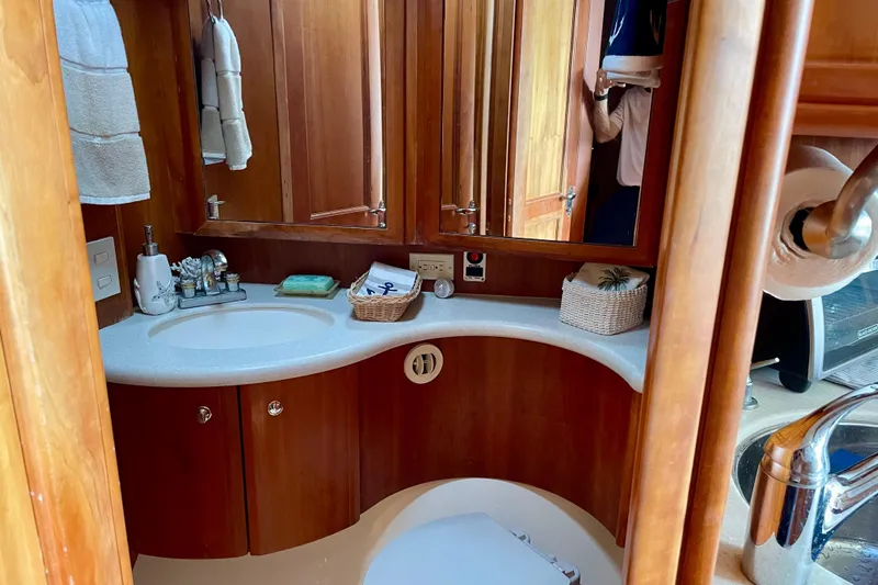  Yacht Photos Pics Luxurious bathroom in a 2003 Silverton 38 Convertible yacht with wooden cabinetry.