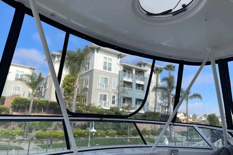  Yacht Photos Pics View from 2003 Silverton 38 Convertible boat, showcasing waterfront buildings and palm trees.