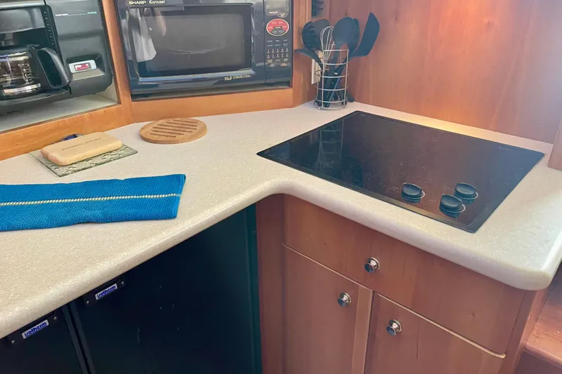  Yacht Photos Pics 2003 Silverton 38 Convertible kitchen with stove, microwave, and countertop accessories.
