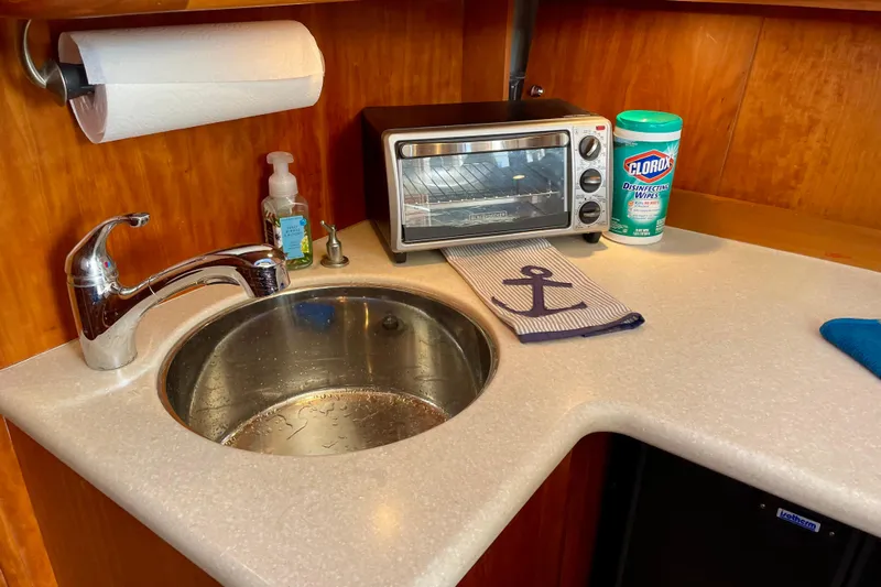  Yacht Photos Pics 2003 Silverton 38 Convertible kitchen with sink, toaster oven, and cleaning supplies.