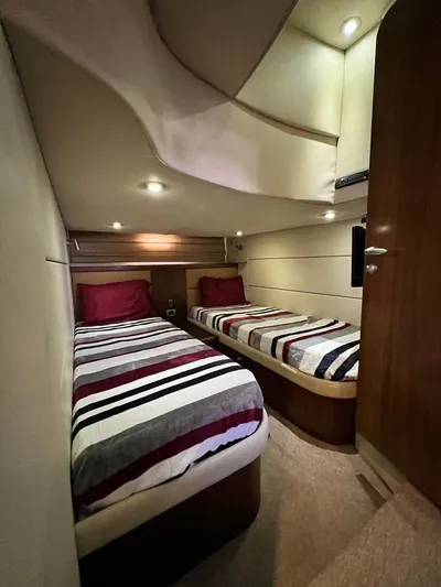 El Andariego Yacht Photos Pics Interior cabin of 2008 Sunseeker Portofino 47 yacht with twin beds and striped bedding.