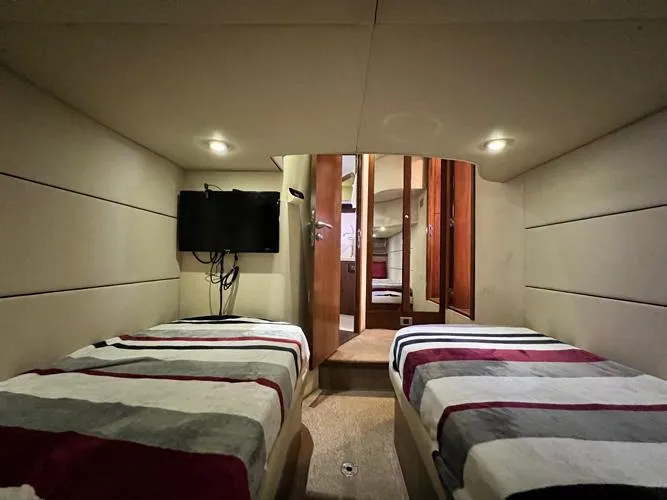 El Andariego Yacht Photos Pics Interior cabin of 2008 Sunseeker Portofino 47 yacht with twin beds and TV.