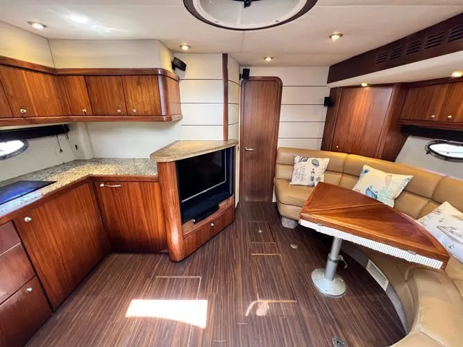 El Andariego Yacht Photos Pics Interior of 2008 Sunseeker Portofino 47 yacht with wood finish and cozy seating area.