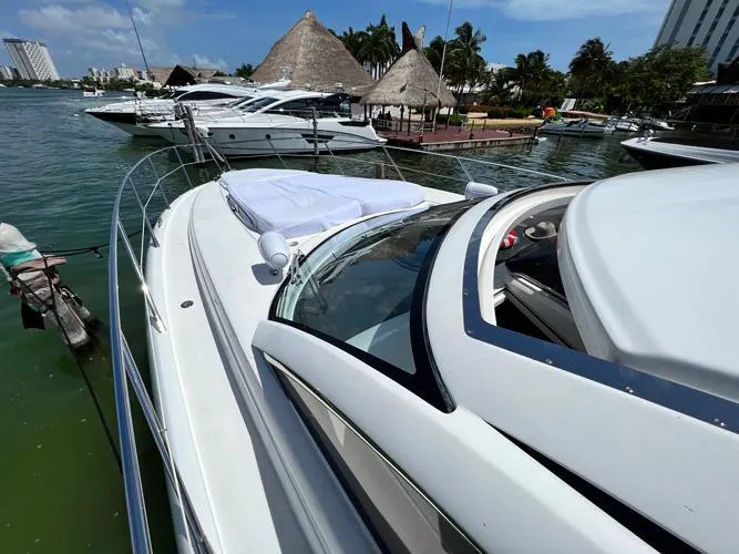 El Andariego Yacht Photos Pics 2008 Sunseeker Portofino 47 yacht docked in a scenic marina setting.