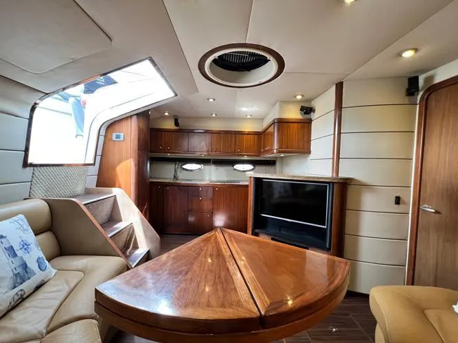 El Andariego Yacht Photos Pics Luxurious interior of 2008 Sunseeker Portofino 47 yacht with wood finishes and modern amenities.