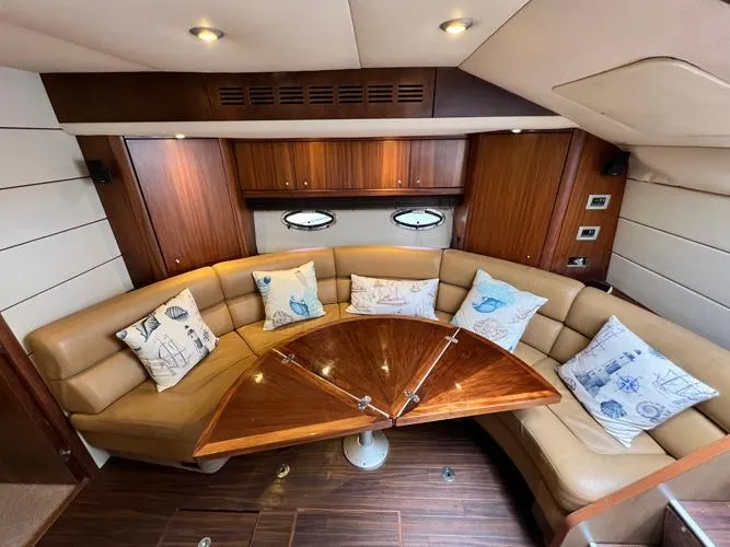 El Andariego Yacht Photos Pics Luxurious interior of 2008 Sunseeker Portofino 47 yacht with elegant seating and wooden table.