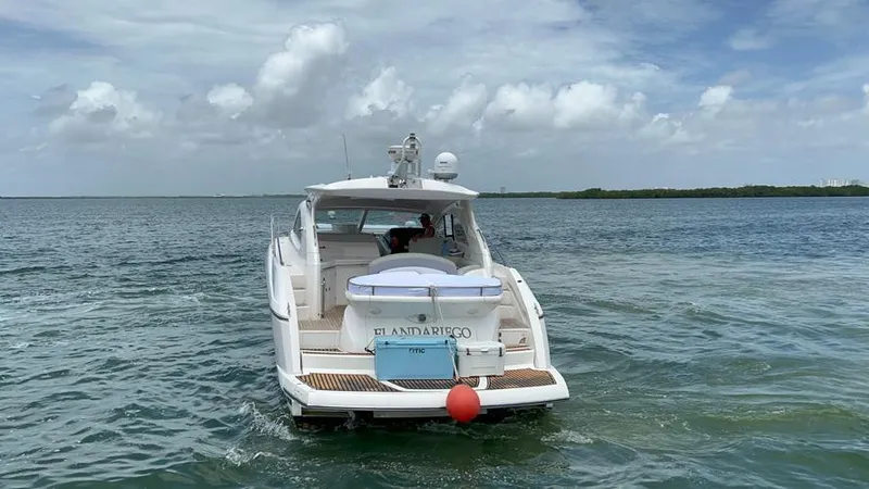 El Andariego Yacht Photos Pics 2008 Sunseeker Portofino 47 yacht cruising on open water under a cloudy sky.