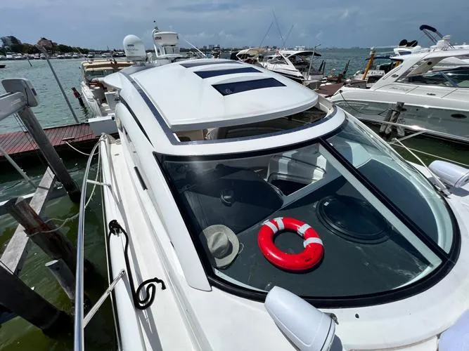 El Andariego Yacht Photos Pics 2008 Sunseeker Portofino 47 yacht docked, featuring sleek design and a red life ring on deck.