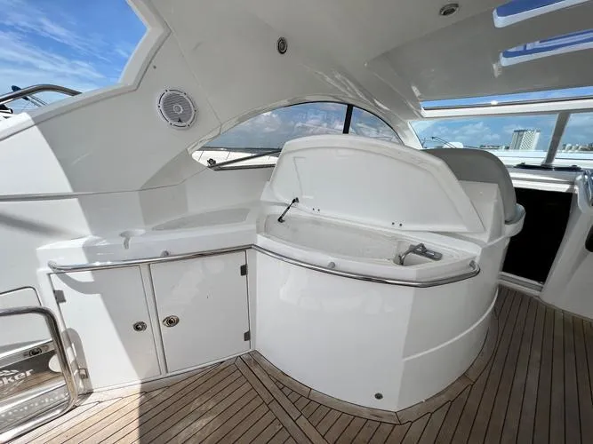 El Andariego Yacht Photos Pics 2008 Sunseeker Portofino 47 yacht interior with sleek white cabinetry and wooden flooring.