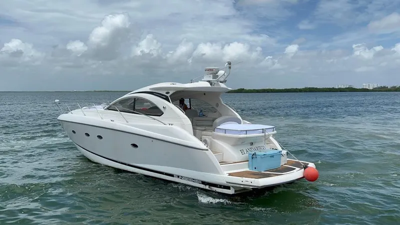 El Andariego Yacht Photos Pics 2008 Sunseeker Portofino 47 yacht cruising on open water under a cloudy sky.