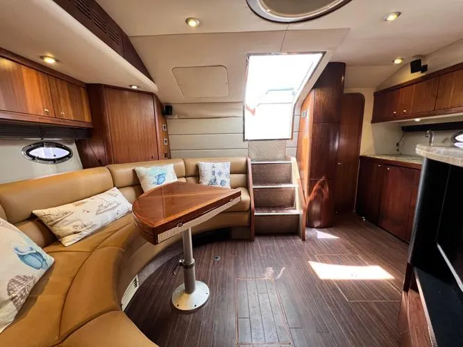 El Andariego Yacht Photos Pics Luxurious interior of 2008 Sunseeker Portofino 47 yacht with elegant wood finishes and plush seating.