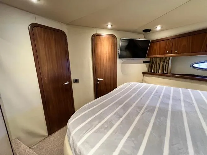 El Andariego Yacht Photos Pics Luxurious cabin interior of 2008 Sunseeker Portofino 47 yacht with wood accents and TV.