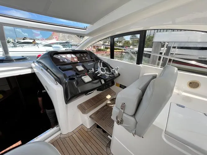 El Andariego Yacht Photos Pics Helm of 2008 Sunseeker Portofino 47 yacht with modern controls and comfortable seating.