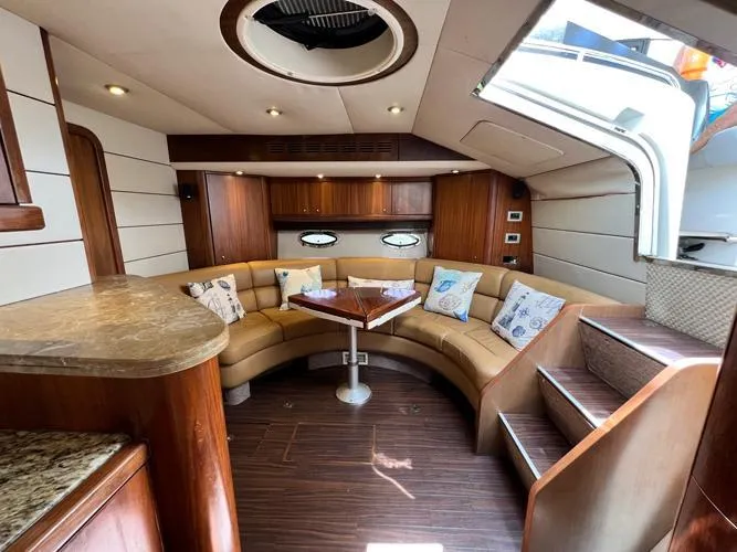 El Andariego Yacht Photos Pics Luxurious interior of 2008 Sunseeker Portofino 47 yacht with elegant seating and wooden finishes.