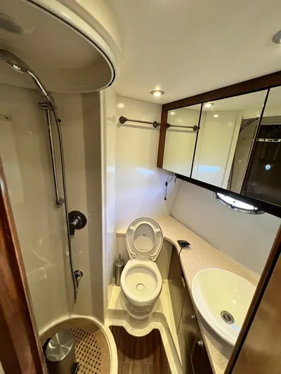 El Andariego Yacht Photos Pics Luxurious bathroom in 2008 Sunseeker Portofino 47 yacht with shower, toilet, and sink.