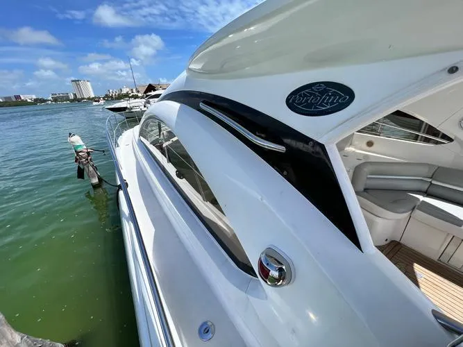 El Andariego Yacht Photos Pics 2008 Sunseeker Portofino 47 yacht docked by the water on a sunny day.
