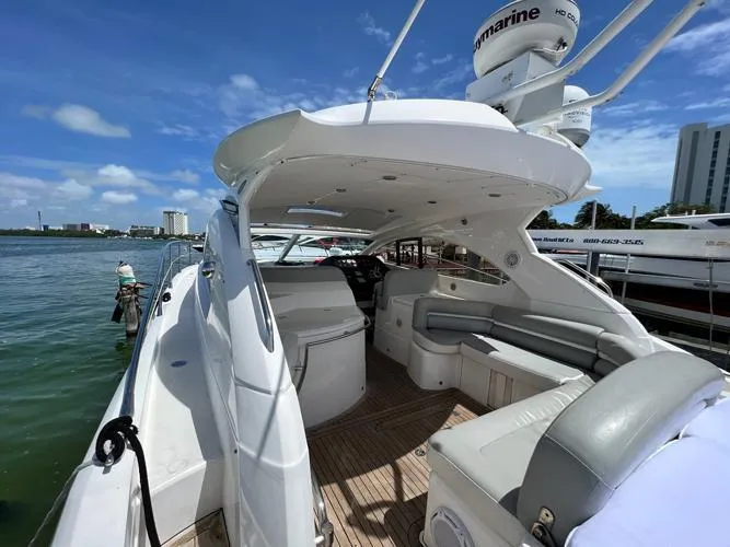 El Andariego Yacht Photos Pics 2008 Sunseeker Portofino 47 yacht with spacious deck and seating, docked under clear skies.