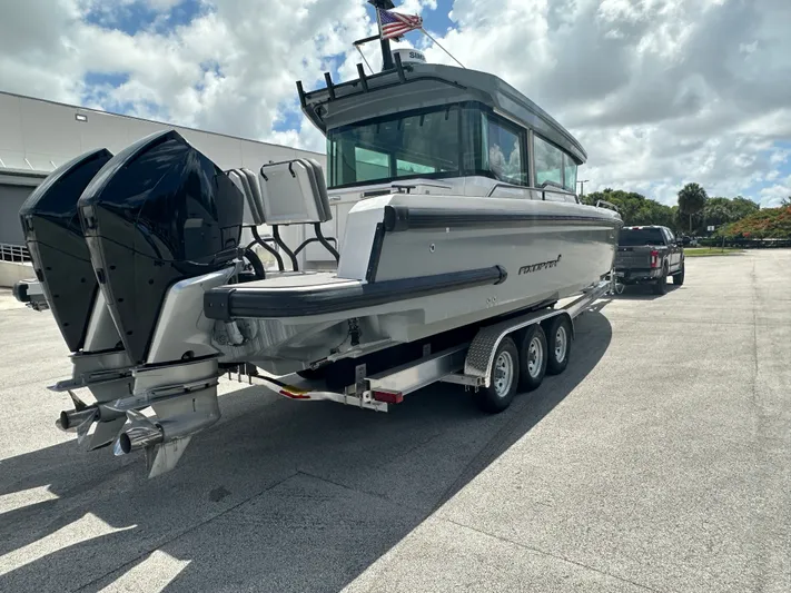  Yacht Photos Pics 2020 Axopar 37 XC CROSS CABIN boat on trailer, parked outdoors.
