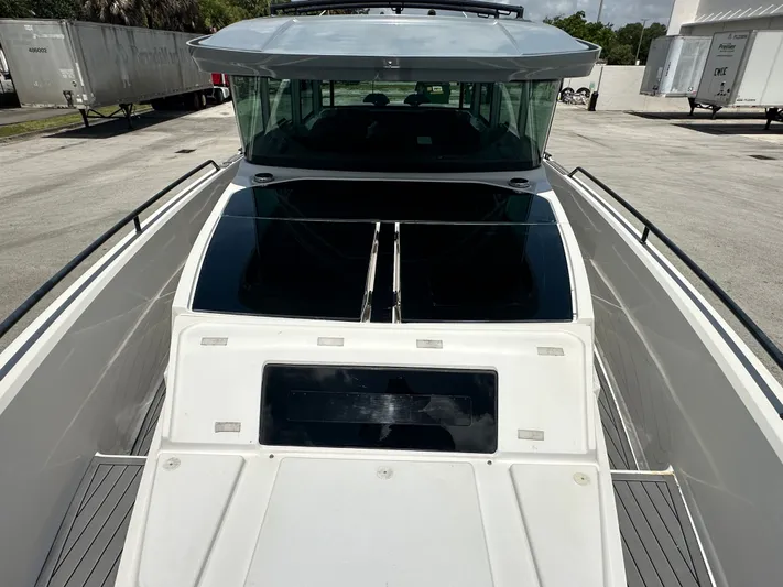  Yacht Photos Pics 2020 Axopar 37 XC CROSS CABIN boat, docked, showcasing sleek design and spacious deck.