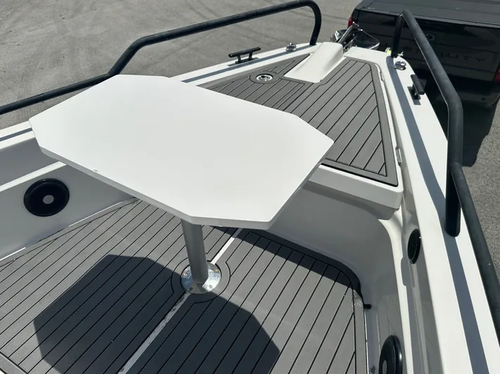  Yacht Photos Pics 2020 Axopar 37 XC CROSS CABIN boat deck with table and seating area.