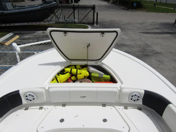  Yacht Photos Pics 2021 Tidewater 2700 Carolina Bay boat with open storage compartment and life jackets.