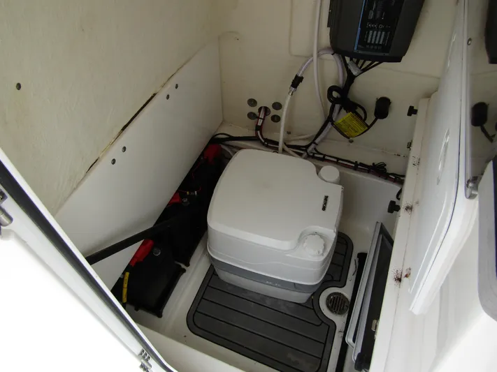  Yacht Photos Pics 2021 Tidewater 2700 Carolina Bay boat interior with portable toilet and storage area.