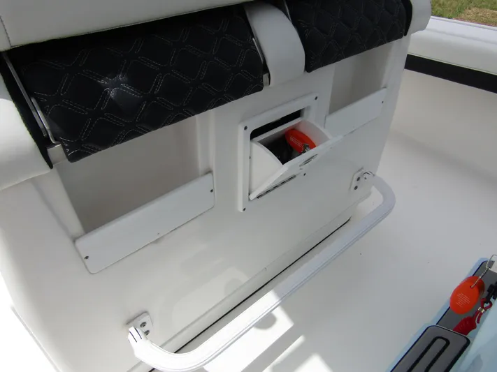  Yacht Photos Pics 2021 Tidewater 2700 Carolina Bay boat interior with storage compartment and seating.