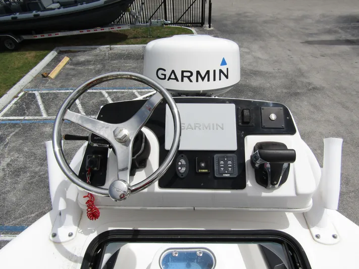  Yacht Photos Pics 2021 Tidewater 2700 Carolina Bay helm with Garmin navigation system and steering wheel.