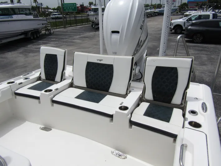  Yacht Photos Pics 2021 Tidewater 2700 Carolina Bay boat seating area with cushioned seats and cup holders.