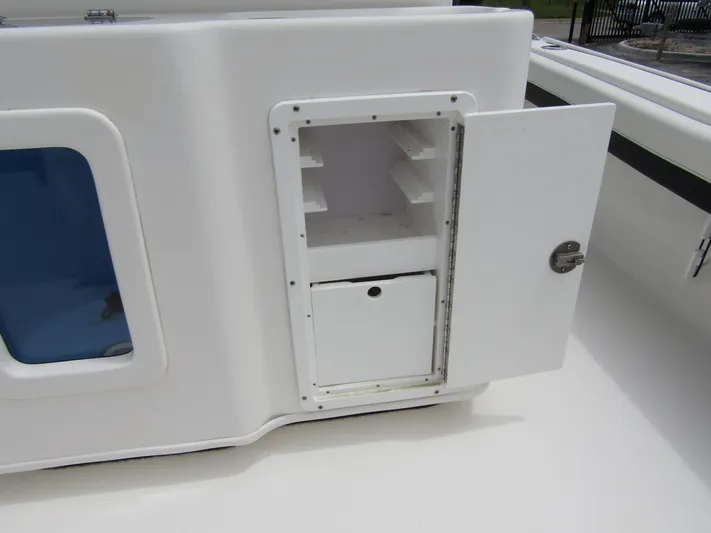 Yacht Photos Pics 2021 Tidewater 2700 Carolina Bay boat storage compartment with open door.
