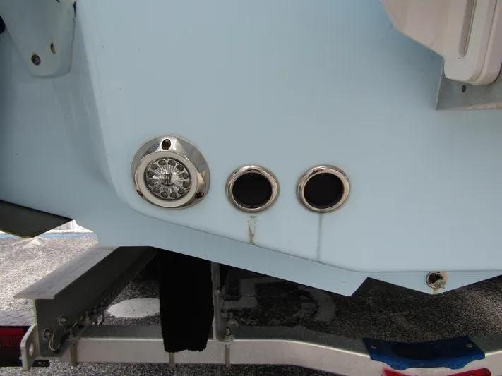  Yacht Photos Pics 2021 Tidewater 2700 Carolina Bay boat stern with trailer, featuring exhaust ports and light.