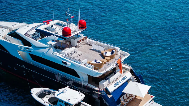 One And Only Yacht Photos Pics Luxurious 2012 Custom Line 100 yacht docked in clear blue waters.