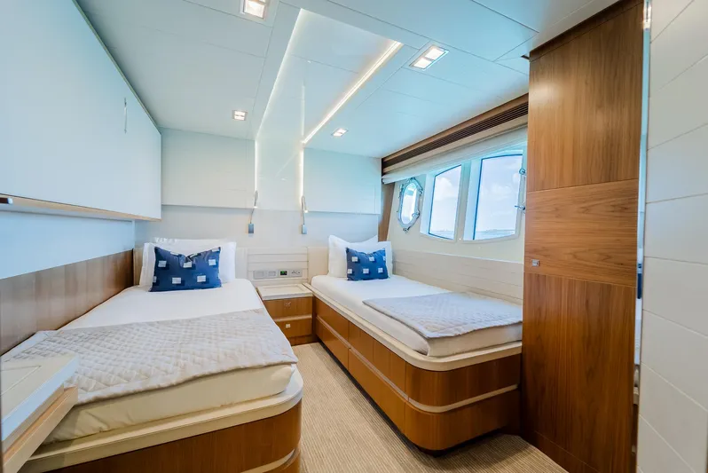 One And Only Yacht Photos Pics Luxurious twin cabin on 2012 Custom Line 100 yacht with modern decor and porthole windows.