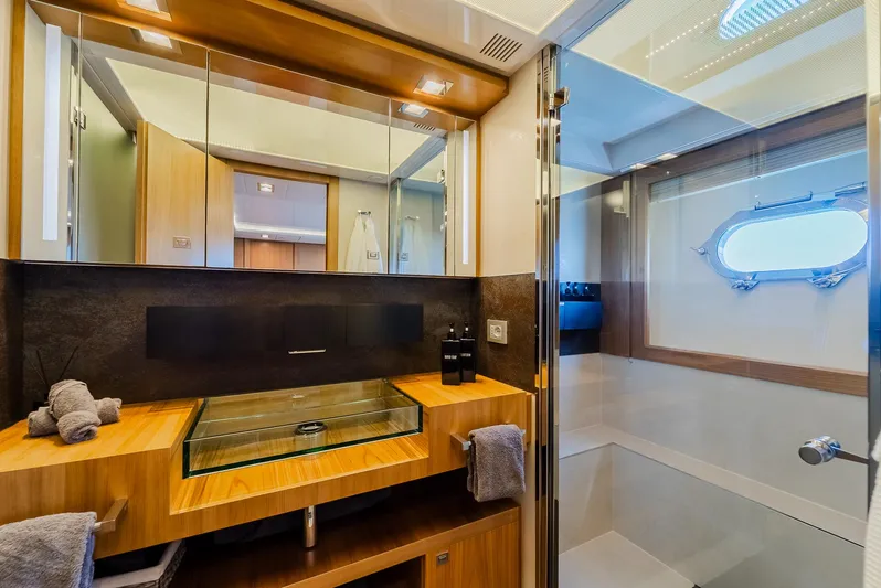 One And Only Yacht Photos Pics Luxurious yacht bathroom with glass sink, wooden accents, and modern fixtures, Custom Line 100, 2012.