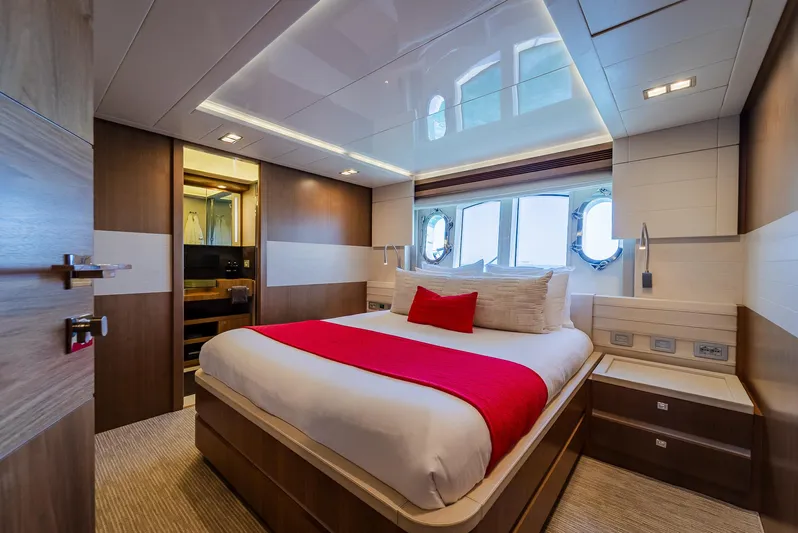 One And Only Yacht Photos Pics Luxurious yacht bedroom with modern design, featuring a comfortable bed and elegant wood finishes.