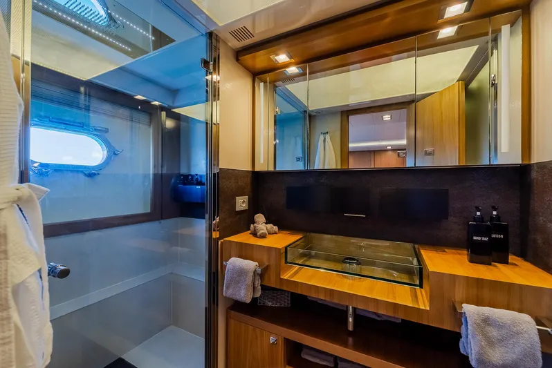 One And Only Yacht Photos Pics Luxurious yacht bathroom with glass shower, modern sink, and wooden cabinetry, Custom Line 100, 2012.
