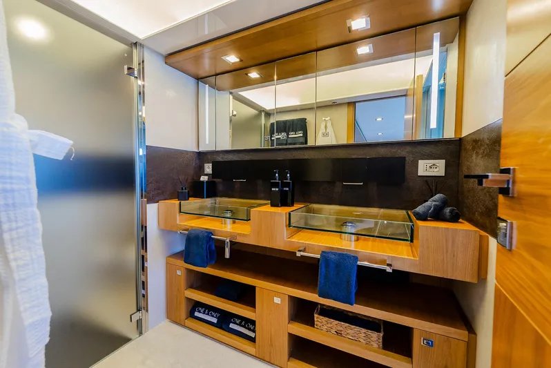 One And Only Yacht Photos Pics Luxurious yacht bathroom with dual glass sinks, wooden cabinetry, and modern fixtures, Custom Line 100, 2012.