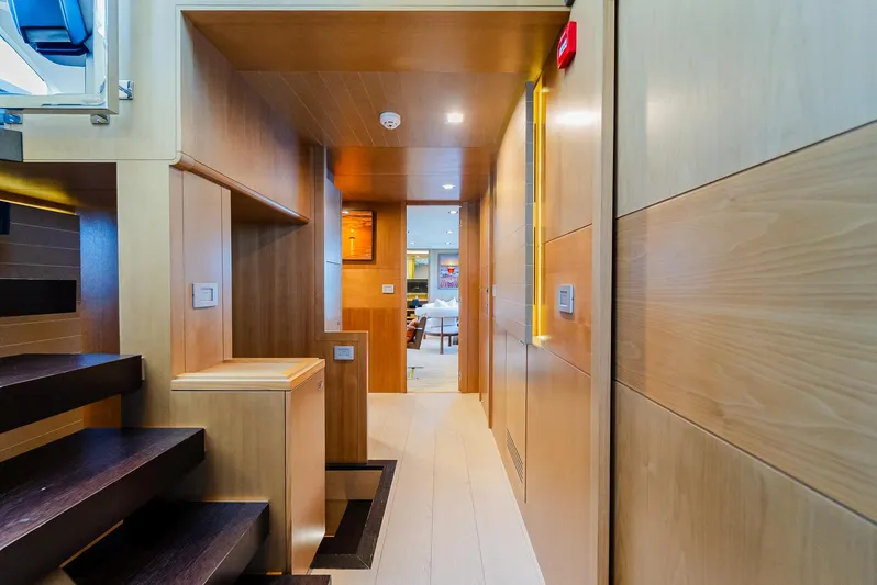 One And Only Yacht Photos Pics Luxurious yacht interior with wooden paneling, modern staircase, and ambient lighting, Custom Line 100, 2012.
