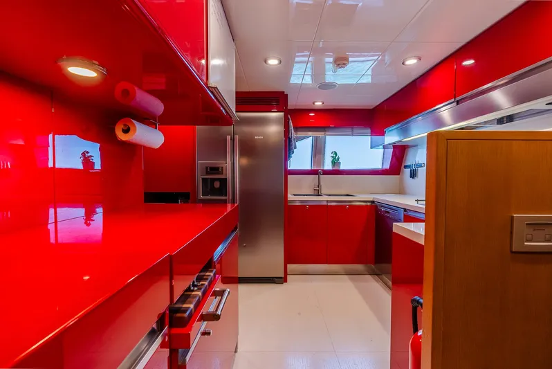 One And Only Yacht Photos Pics Sleek modern kitchen with vibrant red cabinetry and stainless steel appliances, Custom Line 100, 2012.