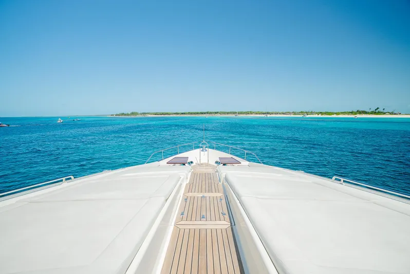 One And Only Yacht Photos Pics Bow view of 2012 Custom Line 100 yacht cruising in clear blue waters.