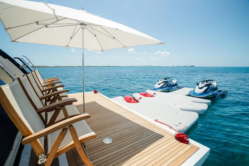 One And Only Yacht Photos Pics Luxury yacht deck with chairs, umbrella, and jet skis on a sunny day, Custom Line 100, 2012.