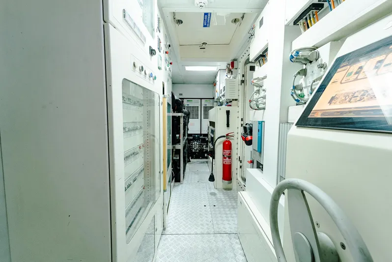 One And Only Yacht Photos Pics Engine room of a 2012 Custom Line 100 yacht, featuring control panels and safety equipment.