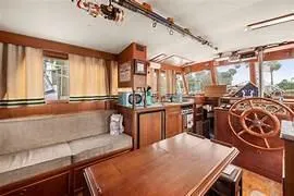 Mancave Yacht Photos Pics Interior of 1984 Grand Banks 36 Classic yacht with wooden furnishings and helm.
