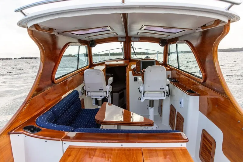 Chaser Yacht Photos Pics 2004 Hinckley Picnic Boat EP interior with polished wood and blue seating on the water.