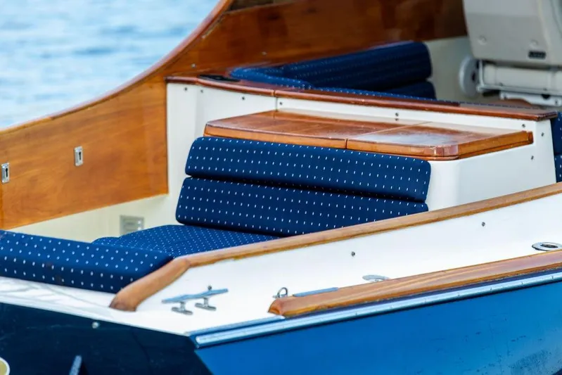 Chaser Yacht Photos Pics 2004 Hinckley Picnic Boat EP with blue cushioned seating and wooden accents.