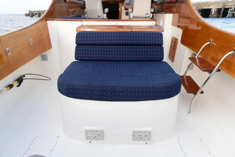 Chaser Yacht Photos Pics 2004 Hinckley Picnic Boat EP interior with blue cushioned seating and wooden accents.