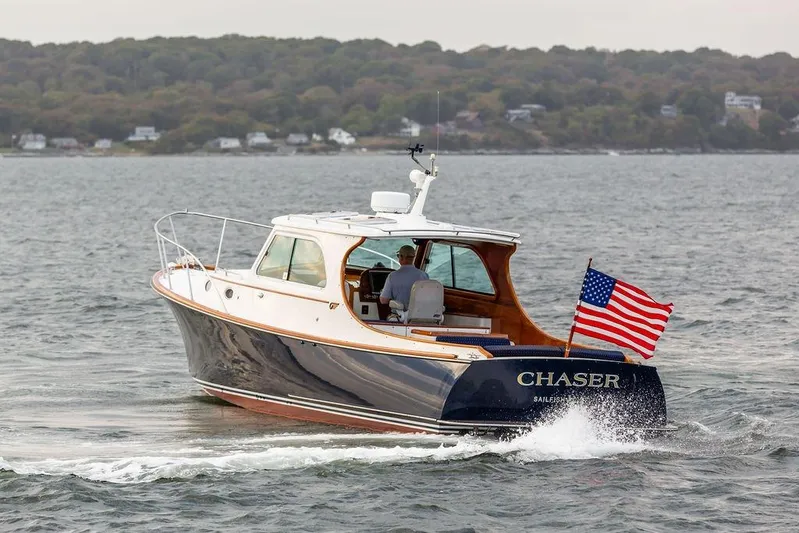 Chaser Yacht Photos Pics 2004 Hinckley Picnic Boat EP cruising with American flag on open water.